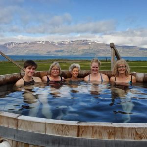 Women in a hot tub on an all womens trip to Iceland