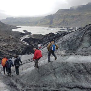 Students on study abroad program on sustainability in south iceland learning about climate change effect on glaciers