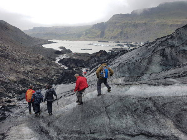 Students on study abroad program on sustainability in south iceland learning about climate change effect on glaciers